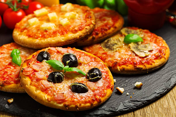 Mix of mini pizzas on a stone try